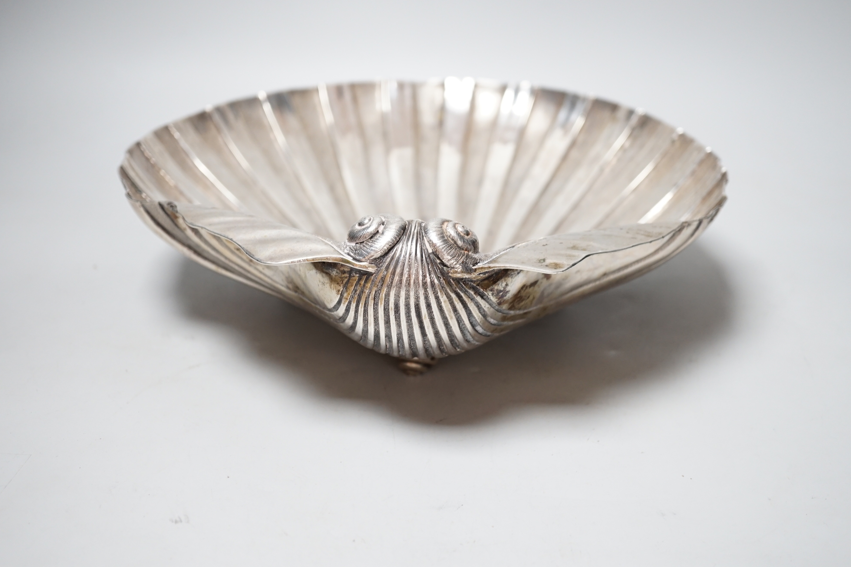 A 19th century Austro-Hungarian with metal fruit bowl, modelled as a half shell, on three shell feet, 34.3cm, 34.4oz.